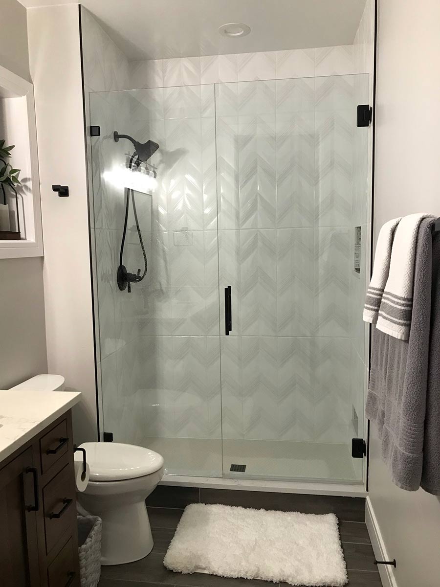 Bathroom remodel with glass shower and black fixtures