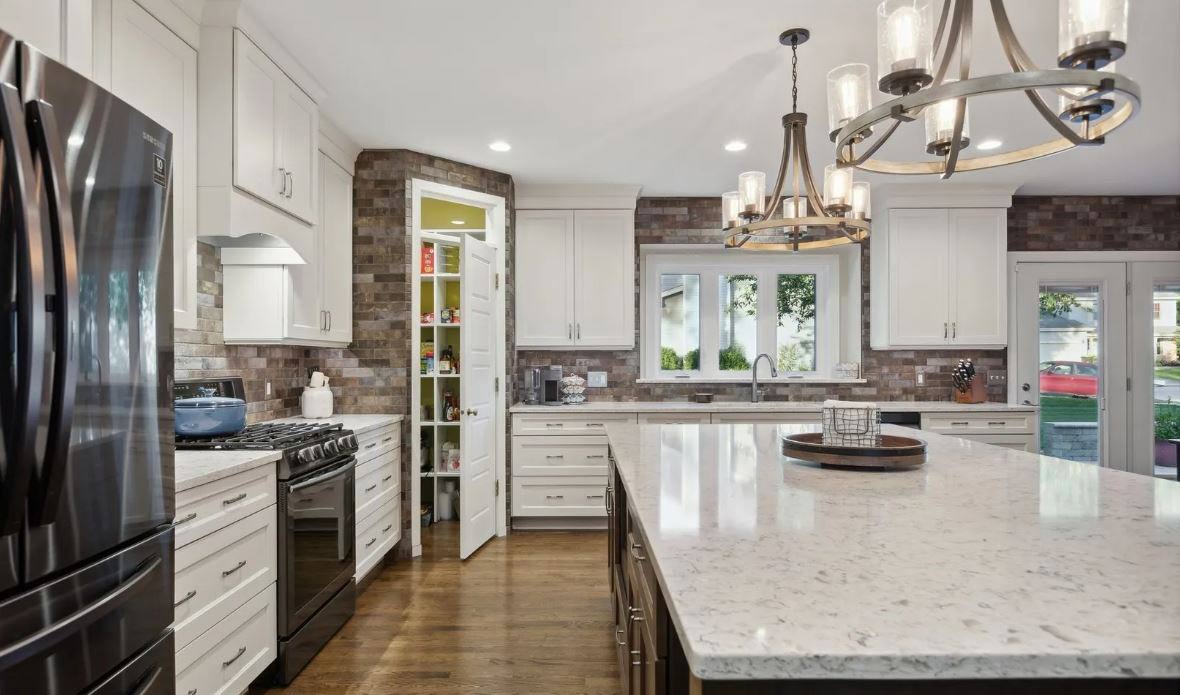 White kitchen with warm stone tile backsplash